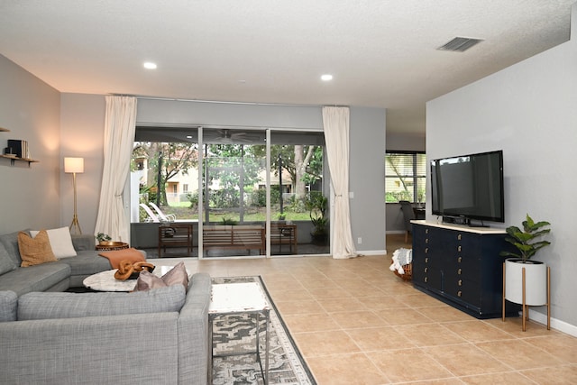 living room with a healthy amount of sunlight and light tile patterned floors