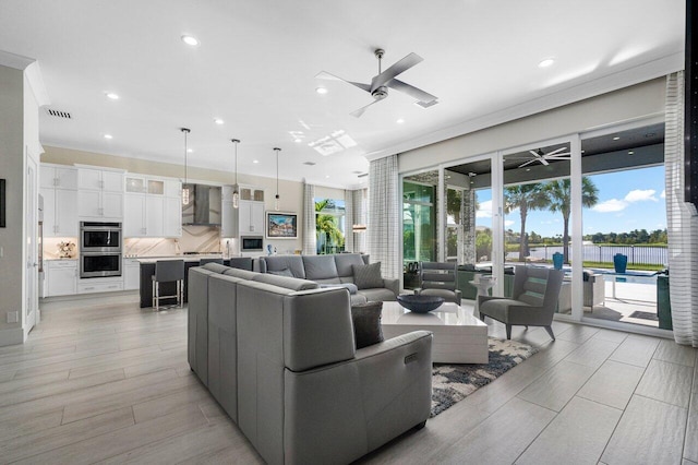 living room featuring ceiling fan and light wood-type flooring