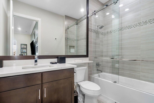 full bathroom with vanity, toilet, and combined bath / shower with glass door