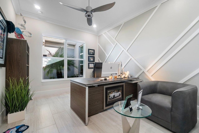 office space with ornamental molding, light wood-type flooring, and ceiling fan