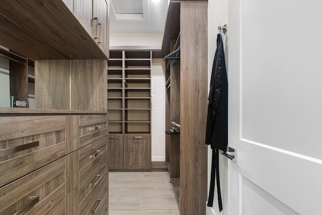 walk in closet with light wood-type flooring