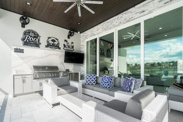 view of patio / terrace with ceiling fan, grilling area, an outdoor kitchen, and outdoor lounge area