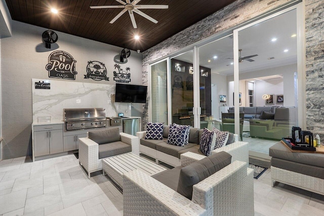 view of patio with ceiling fan, area for grilling, an outdoor kitchen, and an outdoor living space