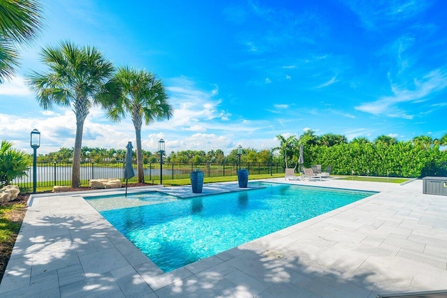 view of pool featuring a patio and a water view