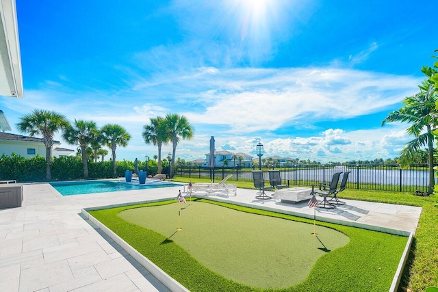 view of pool featuring a water view and a patio