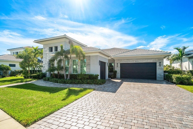 view of front of house with a front yard and a garage