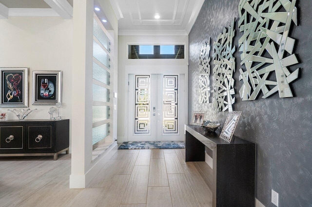 entryway with light hardwood / wood-style flooring and a high ceiling