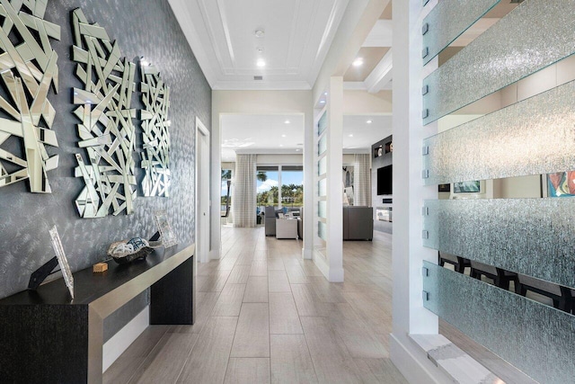 entrance foyer with hardwood / wood-style flooring, a raised ceiling, and ornamental molding