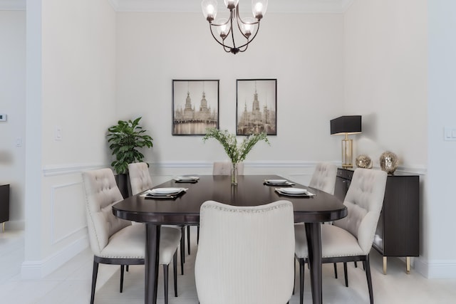 dining room with ornamental molding and an inviting chandelier