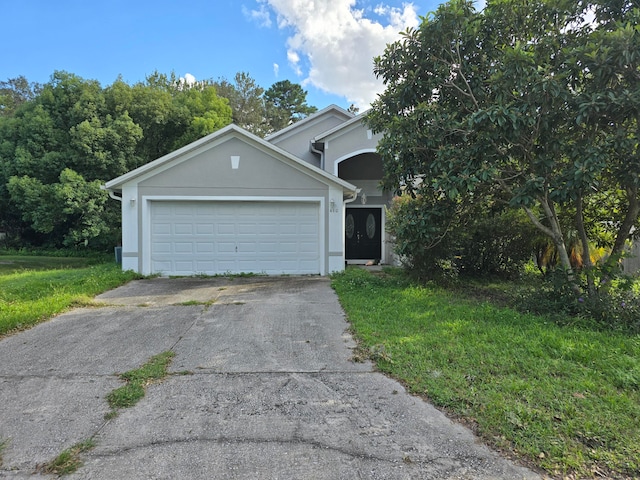 view of front of property with a front lawn and a garage