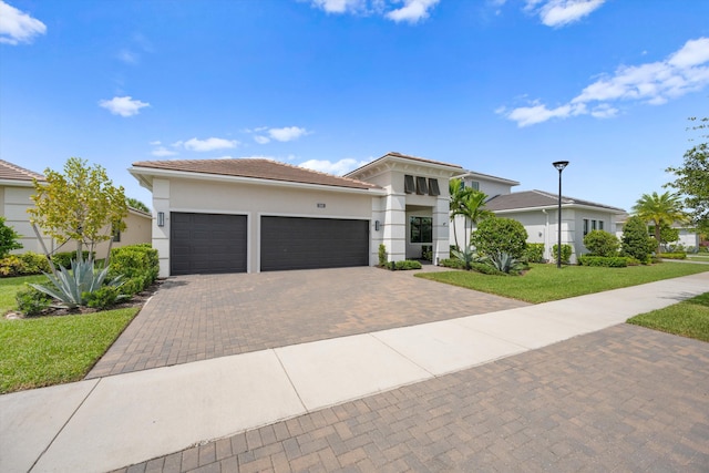 view of front of home with a front lawn and a garage