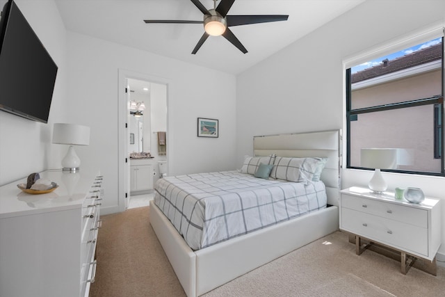 carpeted bedroom with ceiling fan and ensuite bath