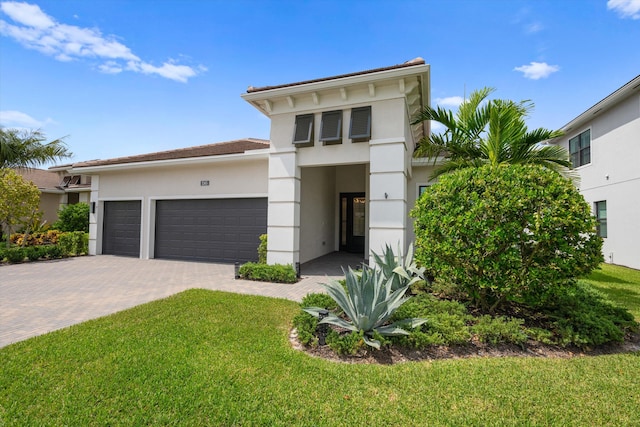 view of front of home featuring a garage and a front yard