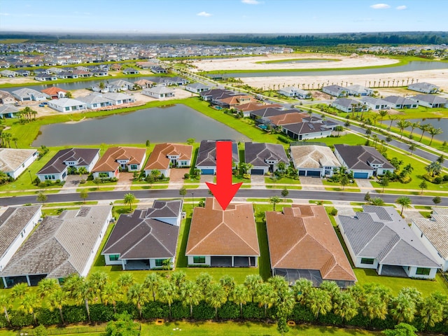 birds eye view of property with a water view