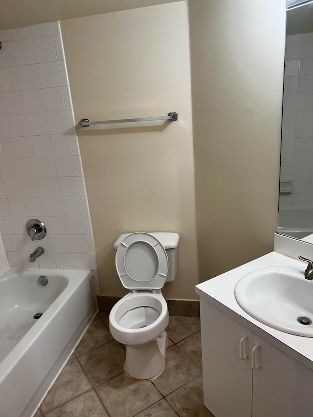 full bathroom featuring tiled shower / bath combo, vanity, tile patterned flooring, and toilet