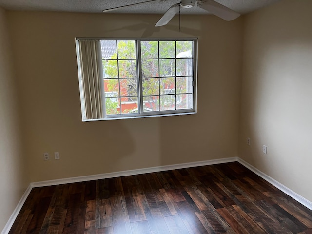 spare room featuring ceiling fan and dark hardwood / wood-style floors