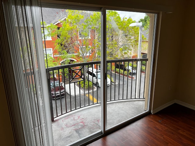 doorway with dark hardwood / wood-style flooring