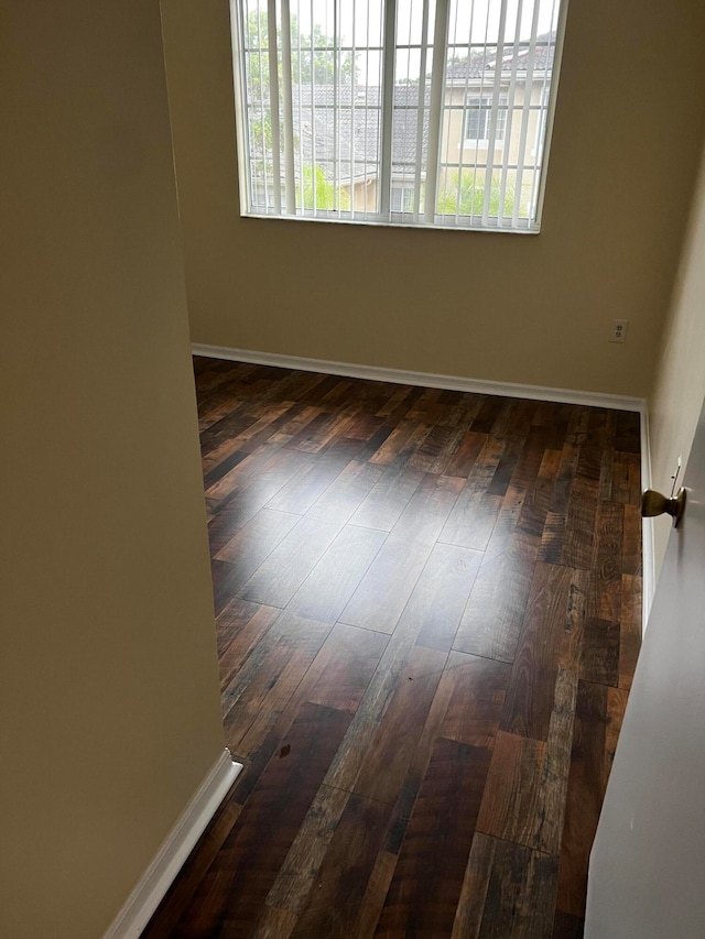 spare room featuring dark hardwood / wood-style floors