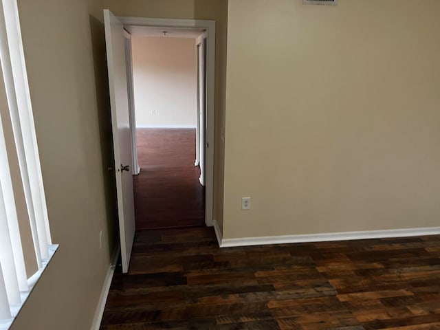 hallway with dark hardwood / wood-style flooring