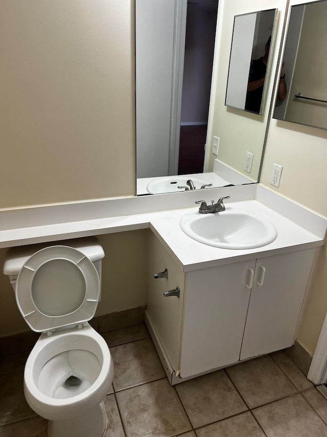 bathroom featuring vanity, tile patterned flooring, and toilet