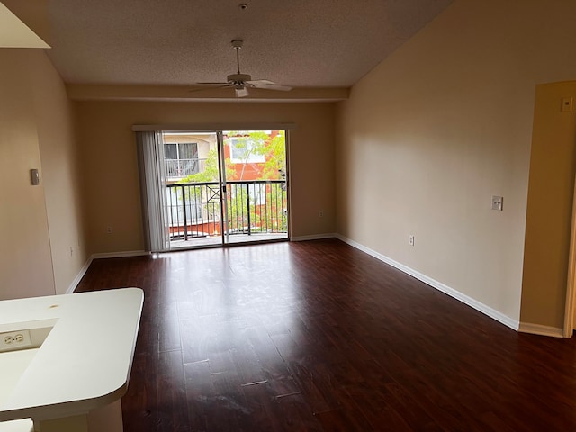 empty room featuring a textured ceiling, ceiling fan, and dark hardwood / wood-style flooring