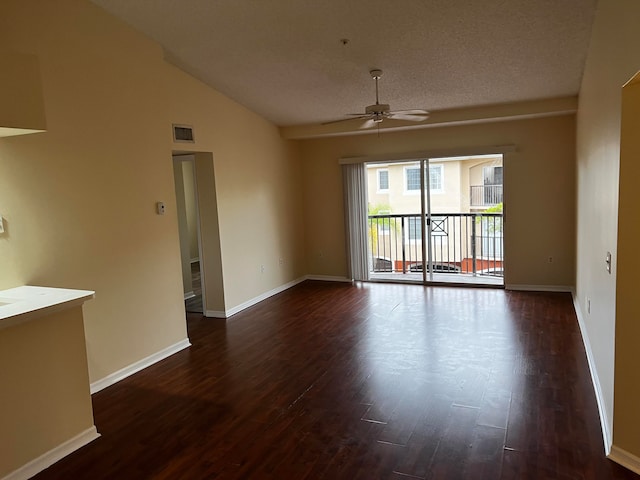 spare room with ceiling fan, a textured ceiling, vaulted ceiling, and dark hardwood / wood-style flooring