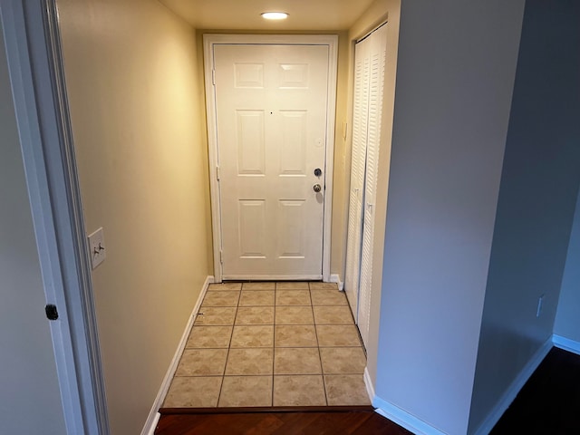 doorway with light tile patterned floors