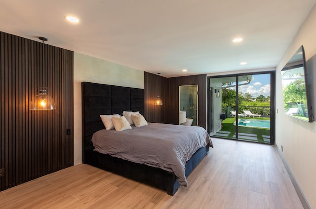 bedroom featuring light wood-type flooring and access to exterior