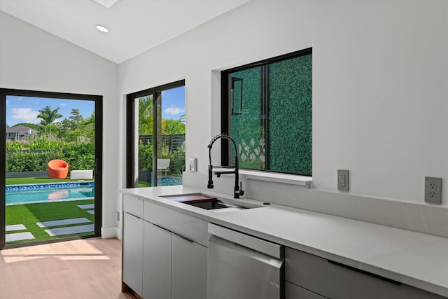 2435 Windsor Way Ct, Wellington, FL 33414 - kitchen with dishwasher, light countertops, a sink, recessed lighting, and vaulted ceiling