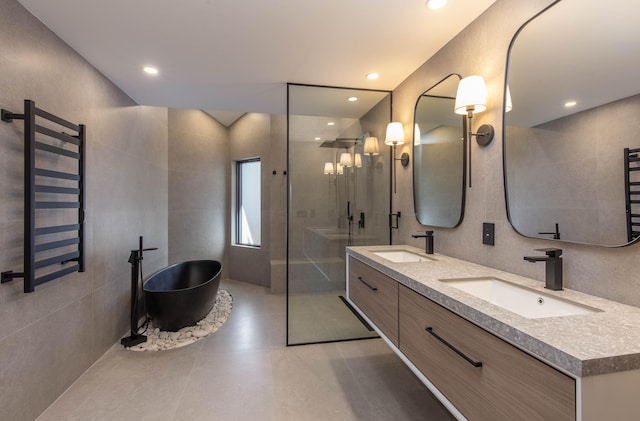 bathroom featuring tile walls, shower with separate bathtub, and vanity