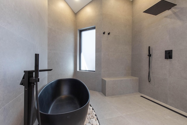 bathroom with tile patterned flooring, lofted ceiling, and sink