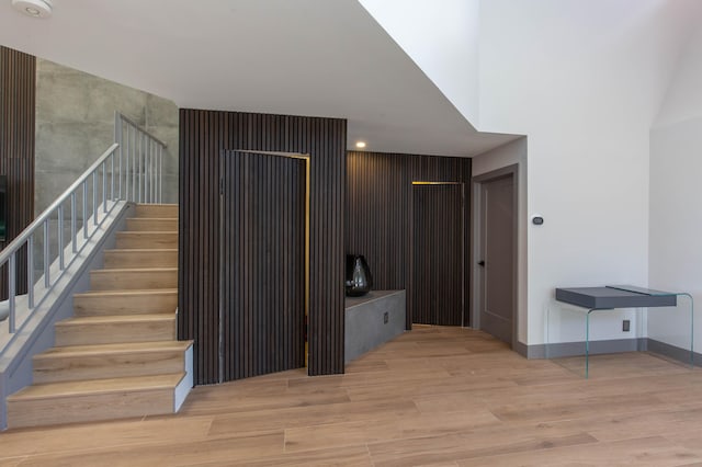 staircase with hardwood / wood-style flooring