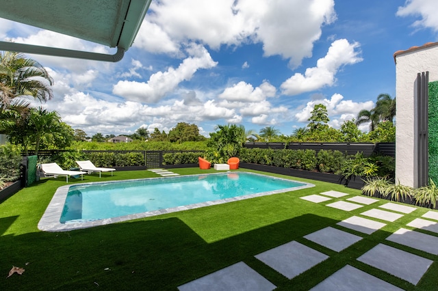 view of swimming pool featuring a lawn and a patio area