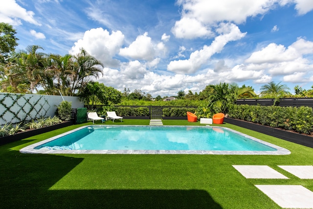 view of pool featuring a yard