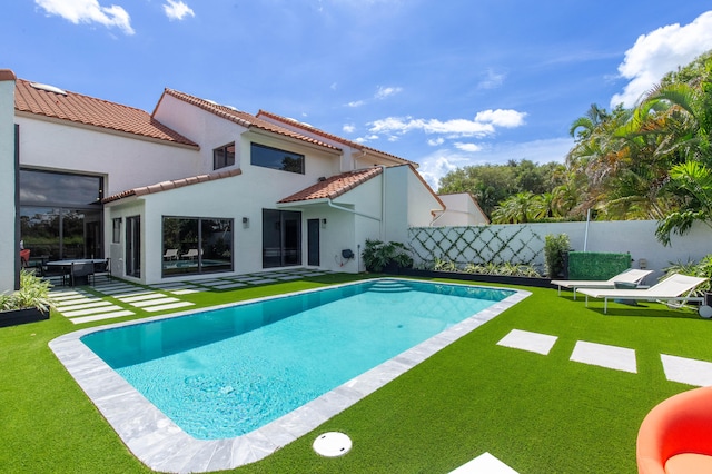 view of swimming pool with a patio area and a yard