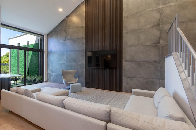 living room featuring high vaulted ceiling and hardwood / wood-style floors