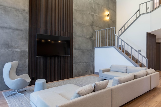 living room featuring a high ceiling and hardwood / wood-style floors