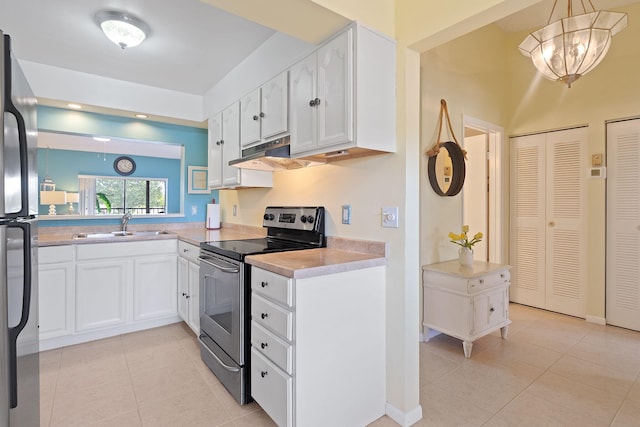 kitchen with white cabinetry, stainless steel appliances, hanging light fixtures, and light tile patterned floors