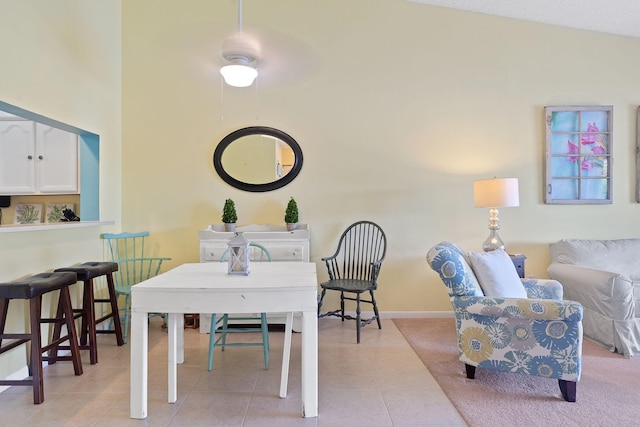 dining area with light tile patterned flooring and lofted ceiling