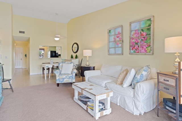 carpeted living room featuring high vaulted ceiling