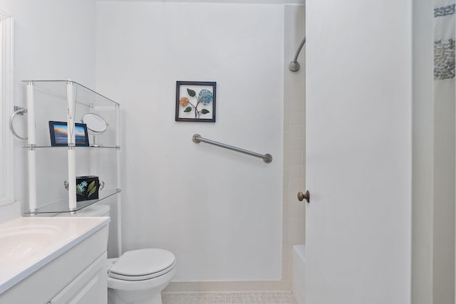 bathroom with vanity, toilet, and tile patterned flooring