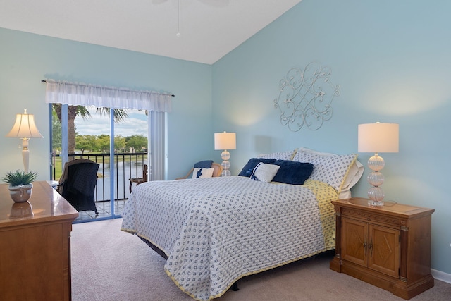 bedroom with carpet flooring, vaulted ceiling, and access to exterior