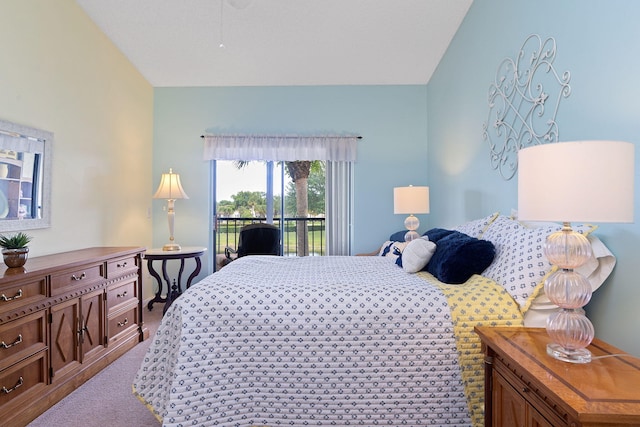 carpeted bedroom with lofted ceiling and access to exterior