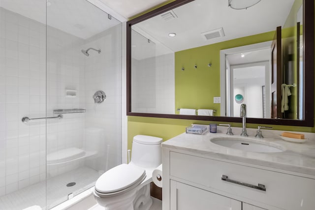 bathroom featuring vanity, toilet, and an enclosed shower