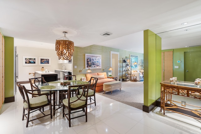 tiled dining area featuring a chandelier