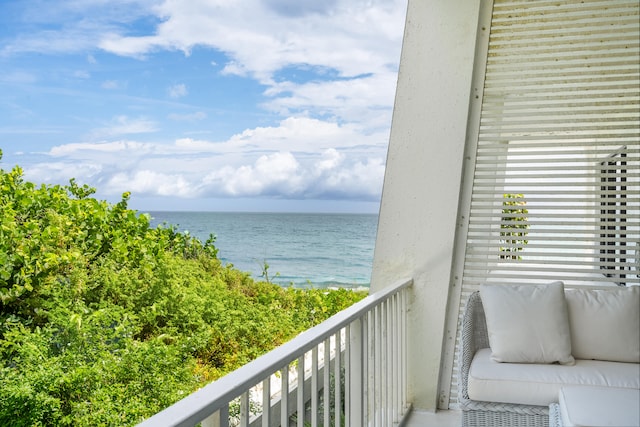 balcony with an outdoor hangout area and a water view