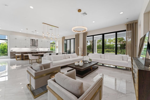 living room featuring a notable chandelier and plenty of natural light