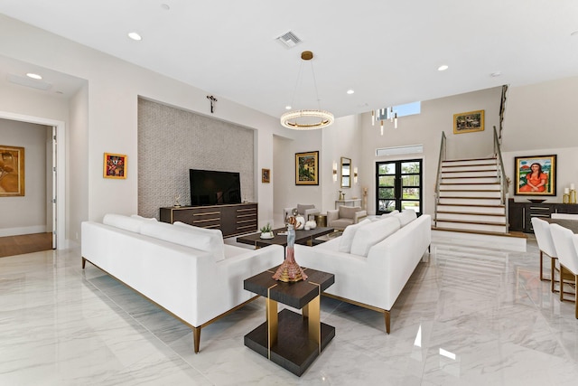 living room with a notable chandelier and french doors