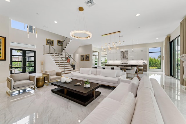 living room featuring french doors and a notable chandelier