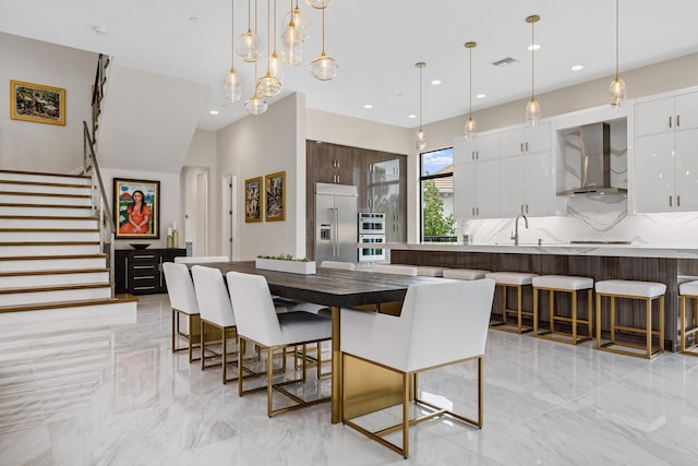 dining room with sink and a chandelier